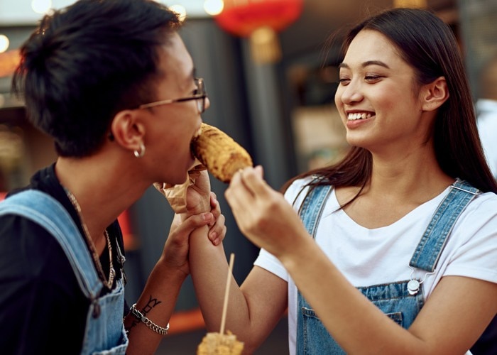 asian woman and man eating