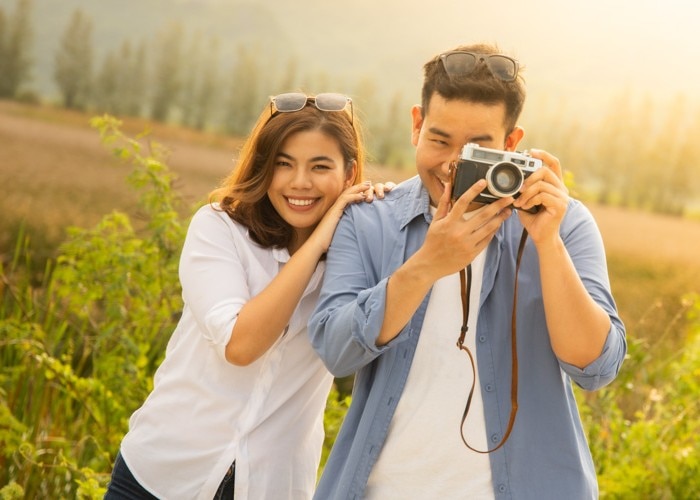 man with woman taking photos