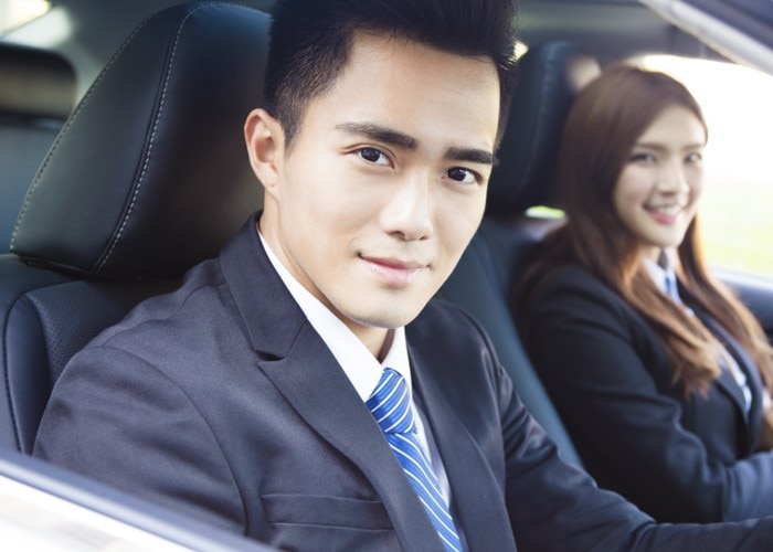 man and woman office style in car