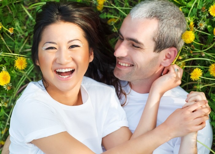 asian woman and man on grass